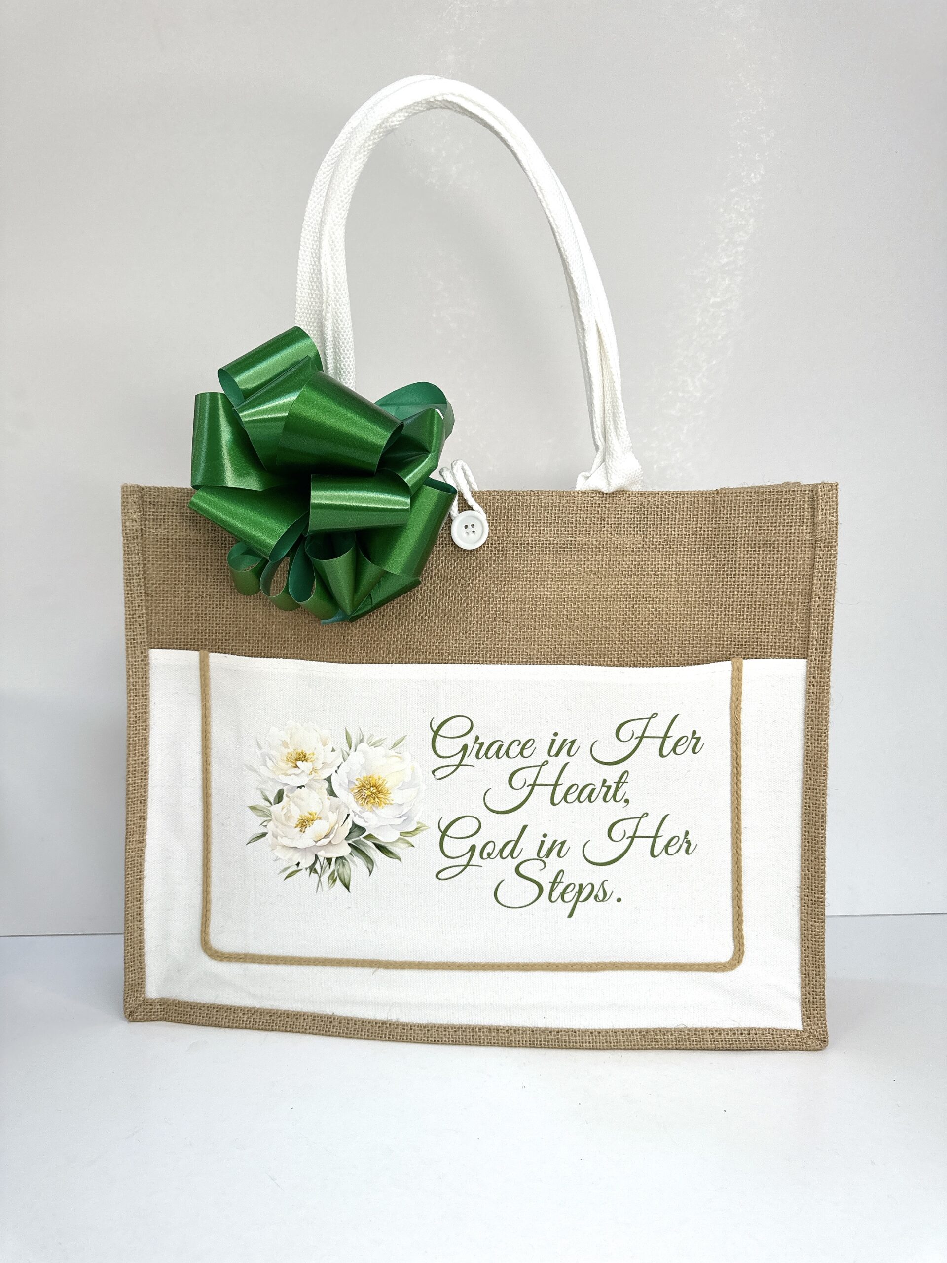 Jute tote bag with floral design and 'Grace in Her Heart, God in Her Steps' inspirational quote by Gifting Kenya
