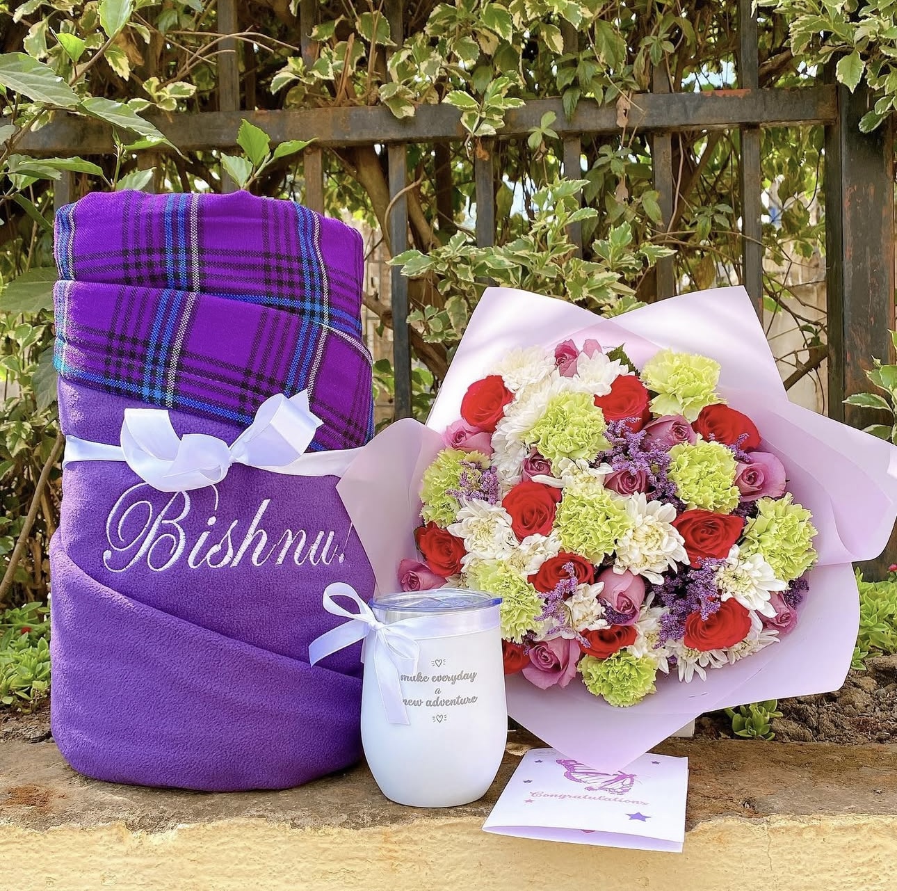 Personalised purple blanket gift set with fresh flower bouquet, scented candle, and greeting card by Gifting Kenya.