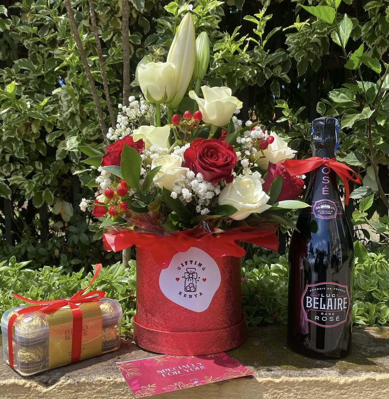 Red and white rose flower box with Luc Belaire Rosé, Ferrero Rocher chocolates, and greeting card by Gifting Kenya.